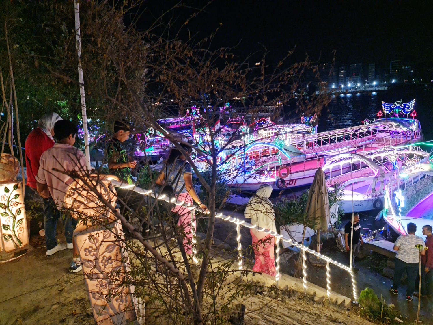 Illuminated Nile felucca boats lit up at night in Cairo