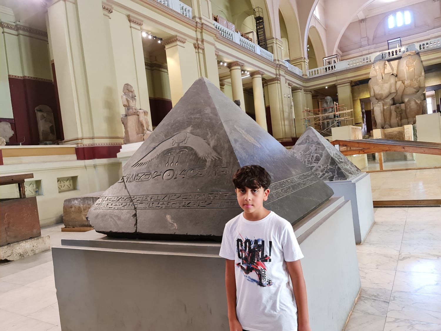 Traveller with a granite pyramidion at the Egyptian Museum in Cairo