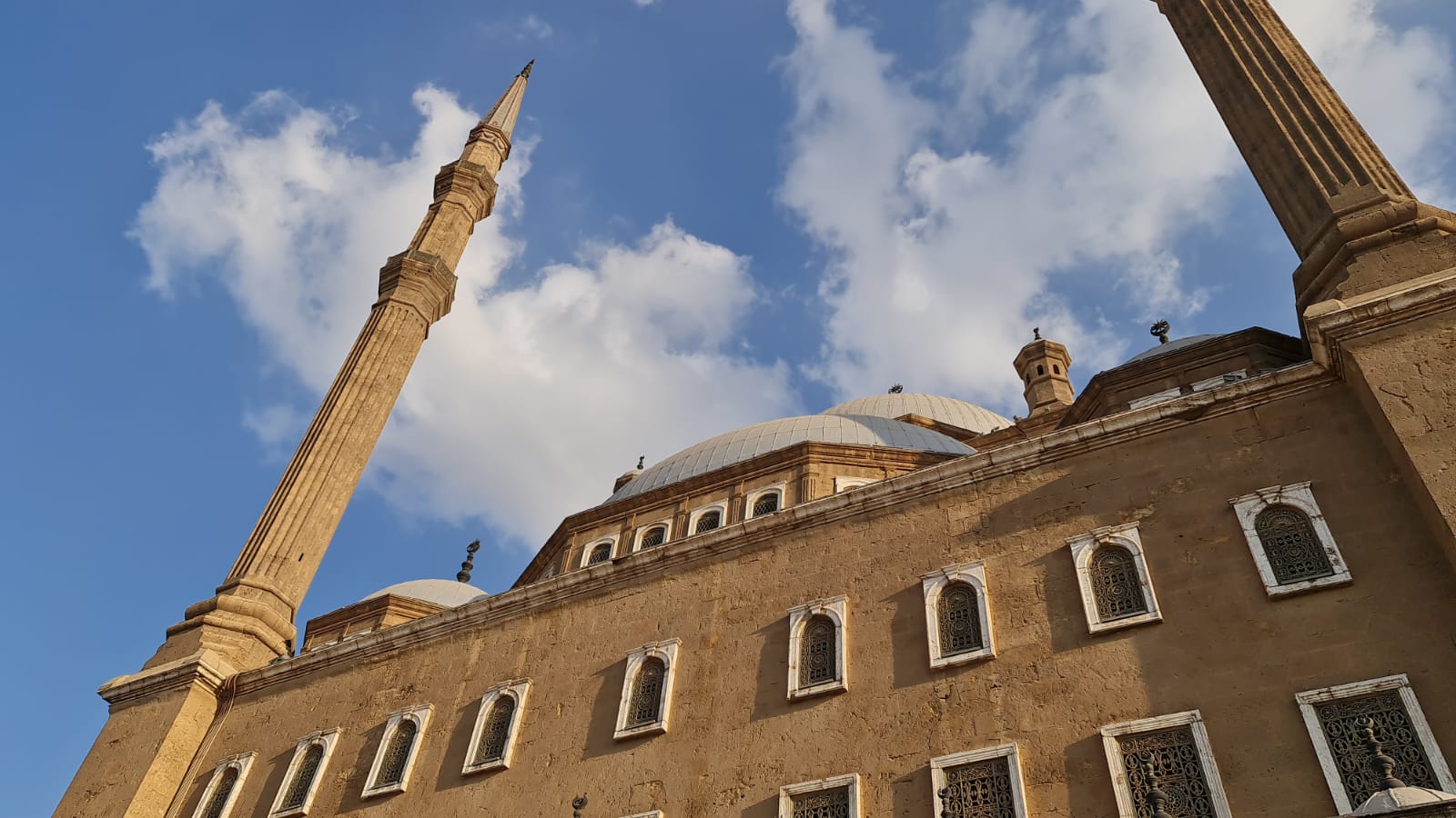 Dramatic upward view of the Muhammad Ali Mosque minarets and domes
