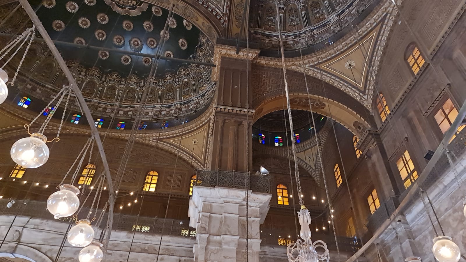 Interior arches and stained glass of the Muhammad Ali Mosque