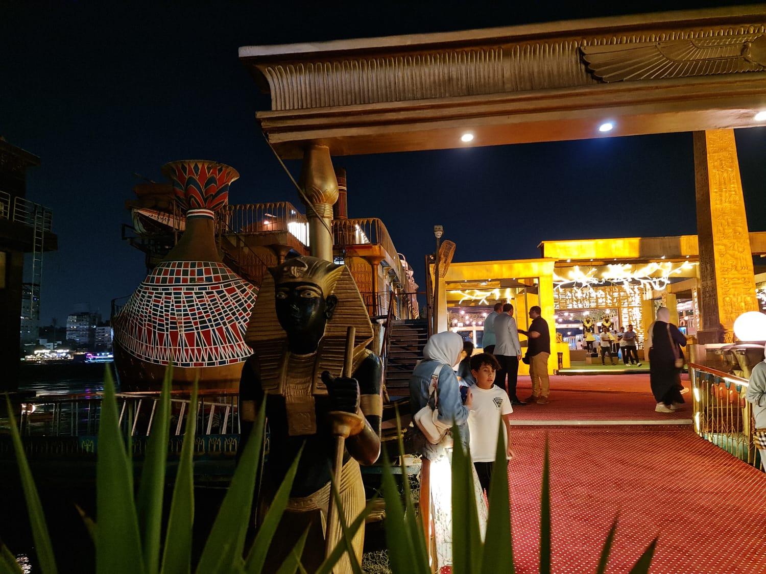 Pharaonic-themed Nile floating restaurant lit up at night in Cairo