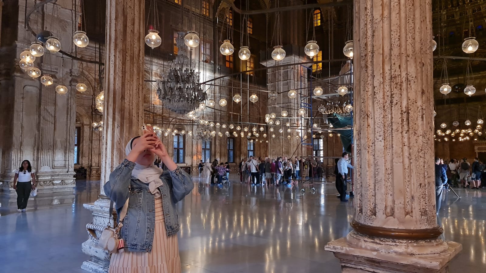 Traveller photographing the vast interior of the Muhammad Ali Mosque